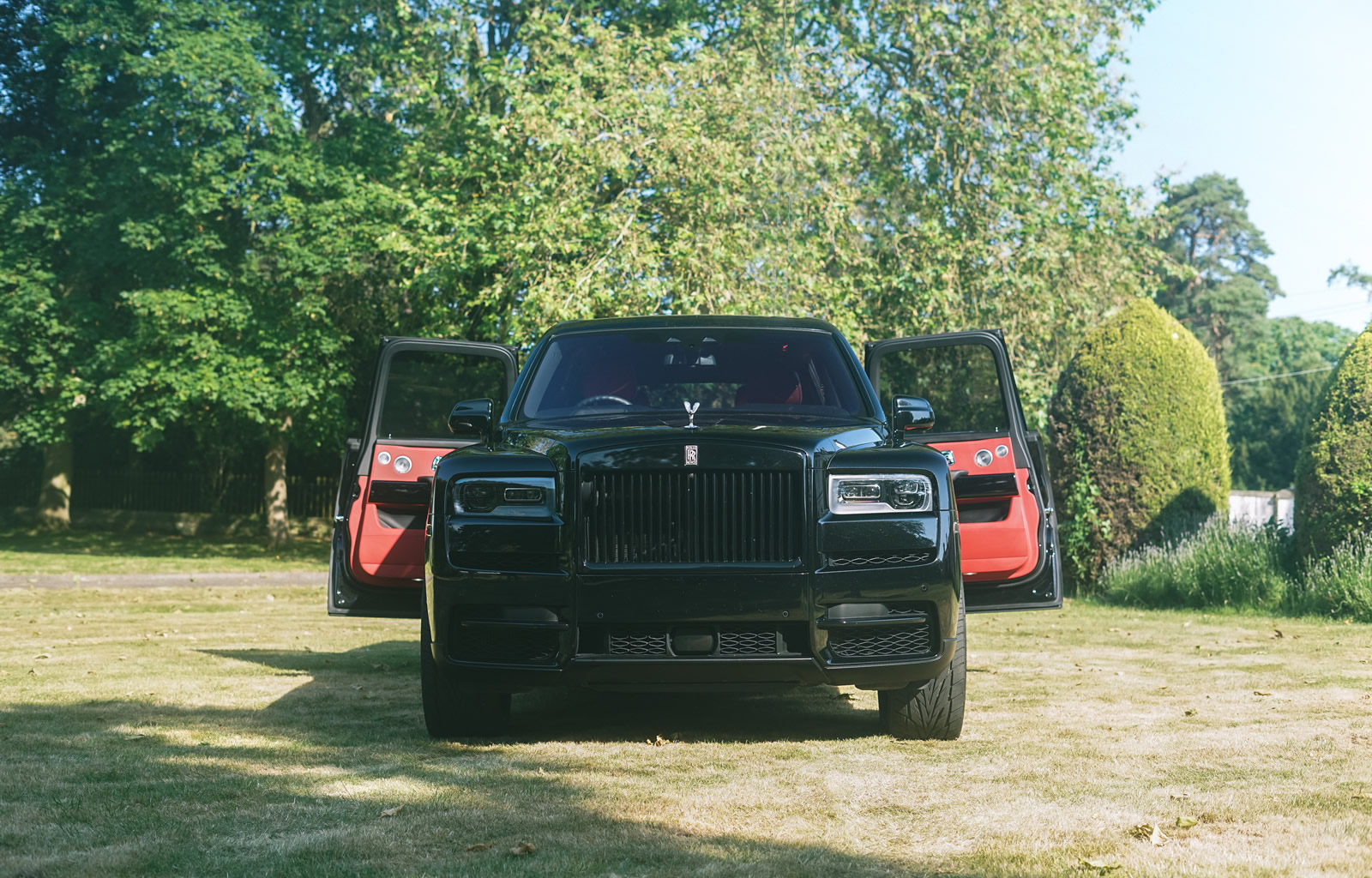 Black Badge Rolls-Royce Cullinan rear coach doors open show red interior