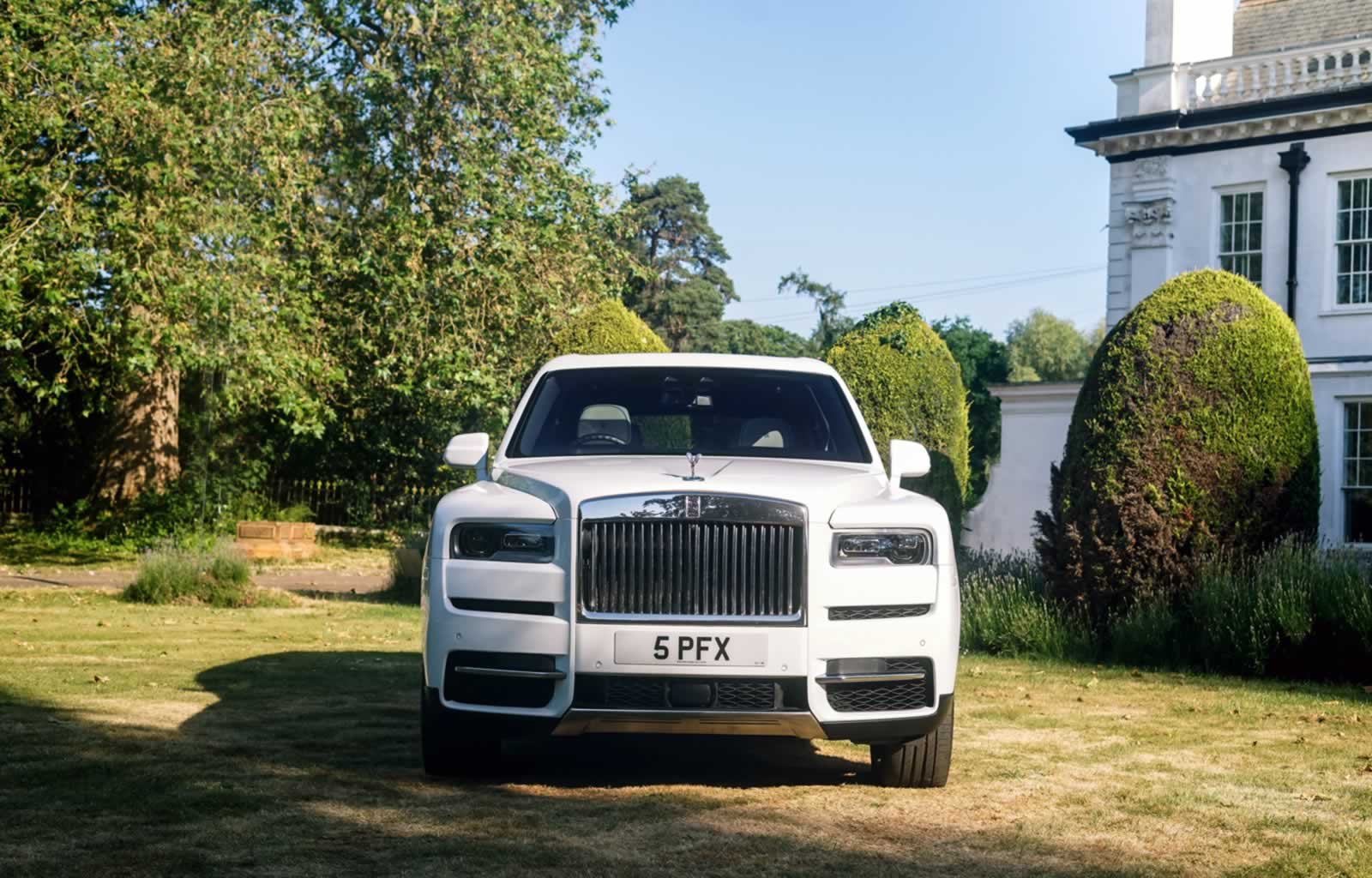Rolls-Royce Cullinan with rear coach doors open and wedding car ribbons decoration